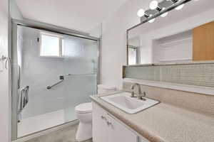 Bathroom featuring vanity and a stall shower
