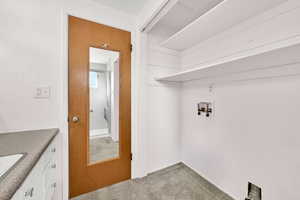 Washroom with carpet and washer hookup