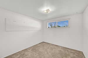 Spare room with carpet and baseboards