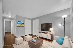 Virtually Staged Living area with brand new LVP flooring and baseboard heating