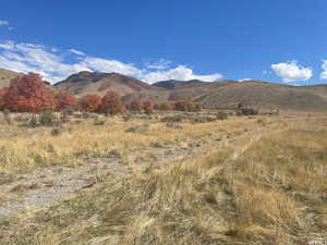 View of mountain backdrop featuring rural landscape