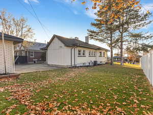 Back of house featuring board and batten siding and a chimney