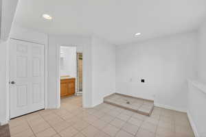 Spare room featuring recessed lighting and light tile patterned floors