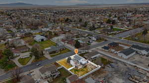 Aerial view of property and surrounding area with nearby suburban area and mountains