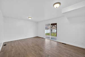 Unfurnished room featuring wood finish floors and baseboards