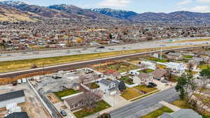 Aerial perspective of suburban area with a mountainous background and a highway