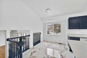 Unfurnished dining area featuring baseboards and light marble finish floors