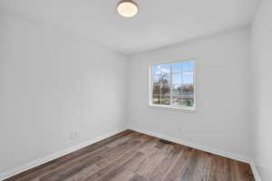 Empty room with wood finished floors and baseboards