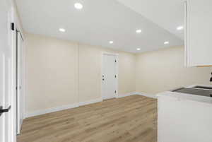 Unfurnished dining area with recessed lighting, light wood-type flooring, and washer / dryer