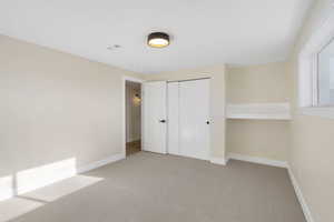 Unfurnished bedroom with carpet and a closet