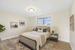 Bedroom with light wood-style flooring and baseboards