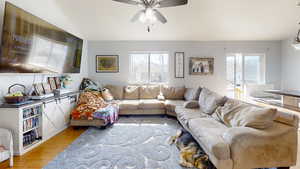 Living area with light wood-style floors and ceiling fan