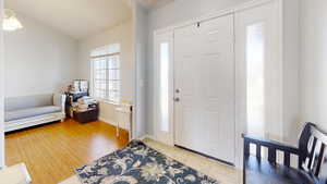 Foyer entrance featuring vaulted ceiling