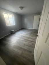 Unfurnished bedroom featuring wood finished floors