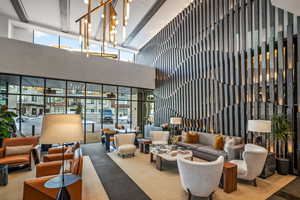 Common area featuring a high ceiling and floor to ceiling windows