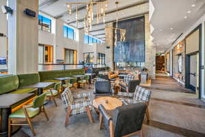 Community lobby with a towering ceiling and recessed lighting