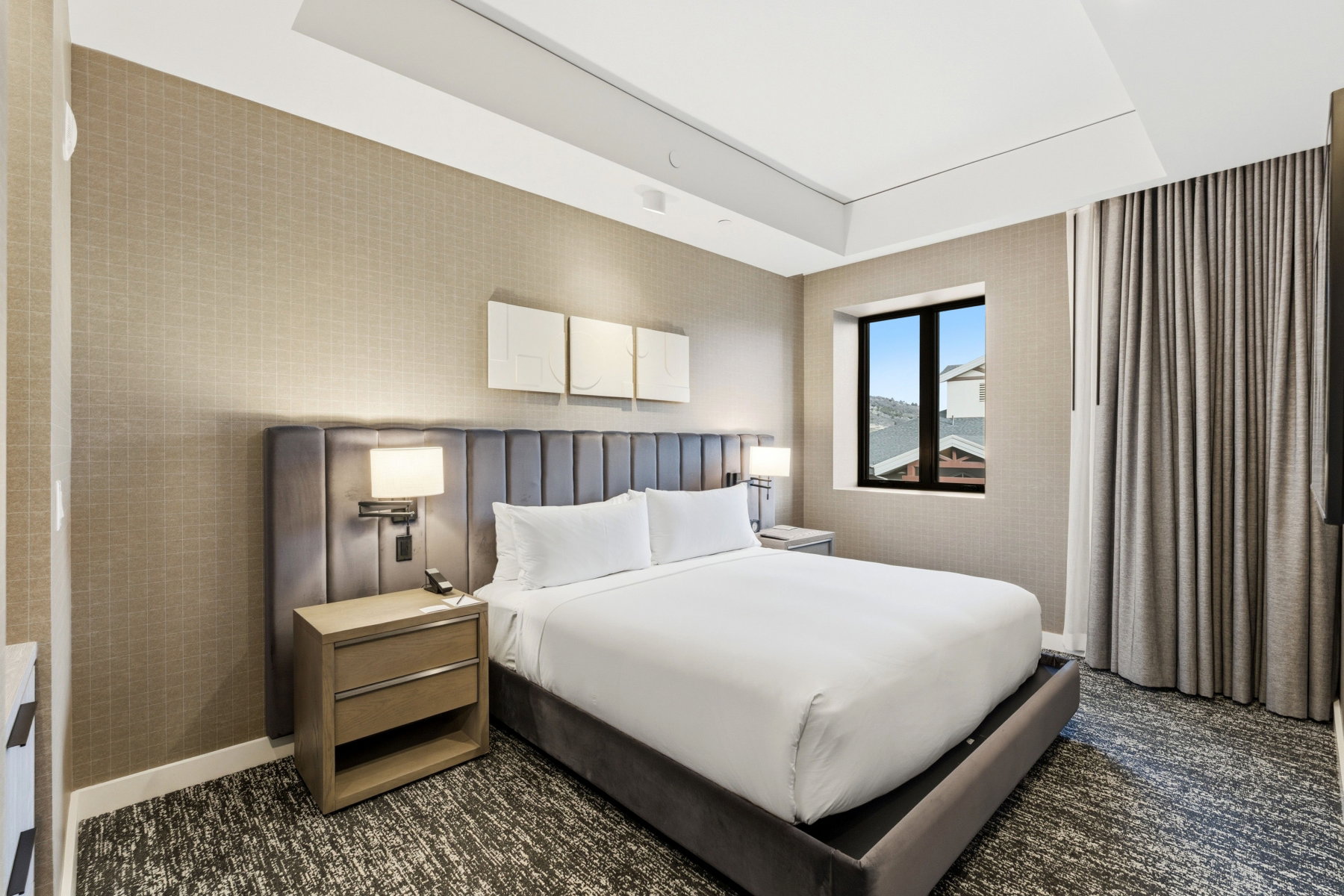 Carpeted bedroom with wallpapered walls and baseboards