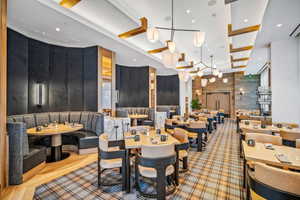 Dining space featuring wooden walls and recessed lighting