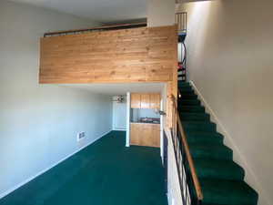 Stairs featuring a ceiling fan and baseboards
