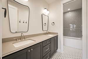 Full bathroom featuring bathing tub / shower combination, double vanity, and recessed lighting