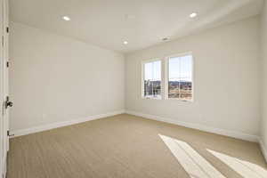 Spare room featuring recessed lighting and light colored carpet