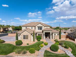 Mediterranean / spanish-style home featuring stone siding, stucco siding, and a tiled roof