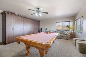 Playroom featuring billiards table, light carpet, and ceiling fan