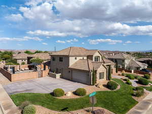 View of front of home featuring a residential view, stone siding, stucco siding, concrete driveway, and a tile roof