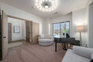 Tiled home office with a chandelier and baseboards