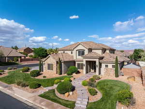 Mediterranean / spanish-style home featuring stone siding, stucco siding, a tile roof, and a residential view