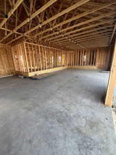 Miscellaneous room with unfinished concrete floors