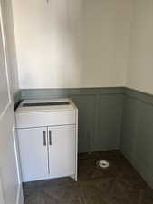 Detailed view of a decorative wall, wainscoting, and parquet flooring