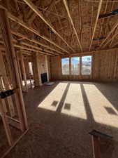 Unfurnished living room featuring plenty of natural light, a fireplace, and heating unit