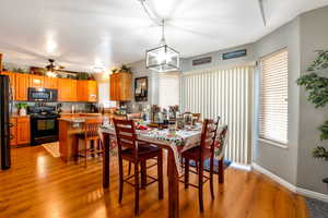 Dining space featuring light wood finished floors and a ceiling fan