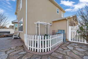 View of home's exterior featuring stucco siding and a patio