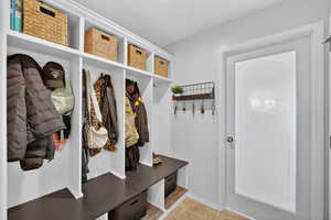 Mudroom featuring baseboards and light tile patterned floors