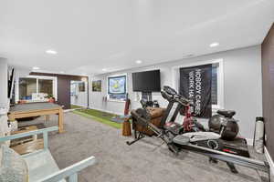 Workout area featuring light colored carpet and recessed lighting