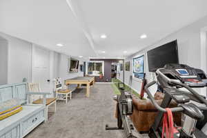 Exercise room with light colored carpet and recessed lighting