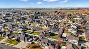 Aerial view of property and surrounding area with nearby suburban area