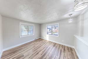 Bedroom with a textured ceiling and light wood-style floors