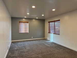 Empty room featuring carpet flooring and recessed lighting