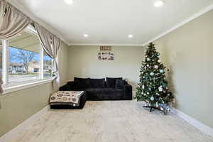 Living room featuring crown molding and recessed lighting