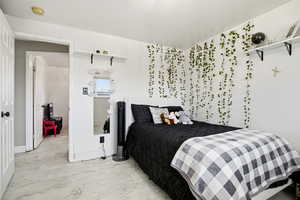 Bedroom with marble finish flooring