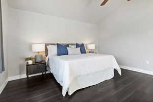 Bedroom with lofted ceiling, dark wood-style floors, and a ceiling fan