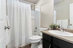 Full bathroom featuring vanity and shower / bath combination with curtain