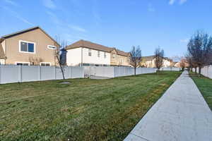 Fenced backyard featuring a residential view