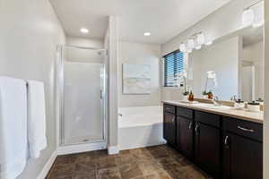 Full bath with vanity, a bath, and a shower stall