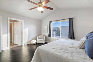 Bedroom with wood finished floors, vaulted ceiling, and ceiling fan