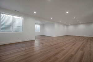 Empty room featuring light wood finished floors and recessed lighting