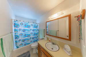 Bathroom with shower / bath combo and vanity